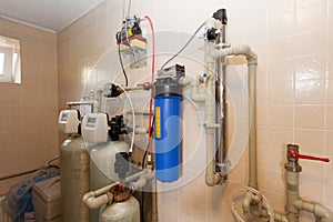 A domestic household boiler room with a new modern solid fuel boiler , heating electric warm water system and pipes.