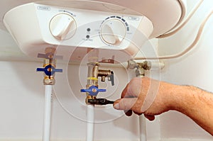 Domestic plumbing connections. Connection of home water heater. Fixing electric water heater boiler