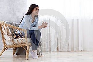 Domestic Relax. Smiling Korean Lady Resting In Armchair With Coffee At Home