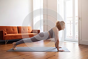 Domestic Sports. Smiling Senior Woman Doing Plank Exercise At Home