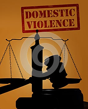Domestic Violence and gavel with scales photo