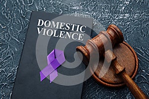 Domestic violence law and gavel on grey table