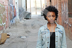 Domestic violence, portrait of abused and hurt young woman showing sadness outdoors with copy space