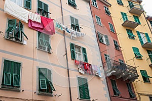Domestic washing hangs drying against walls of multi-level apart