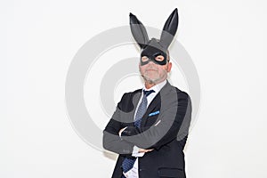 Dominant businessman wearing rabbit mask in Easter fetish