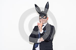 Dominant businessman wearing rabbit mask in Easter fetish