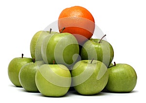 Domination concepts - orange on pyramyd of apples photo