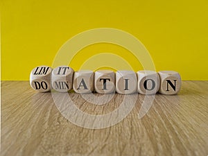 Domination or limitation symbol. Turned cubes, changes the word domination to limitation. Beautiful wooden table, yellow