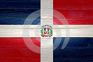 Dominican Republic flag painted on old wood plank background. Brushed wooden board texture. Wooden texture background flag of
