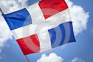 Dominican Republic National Flag Waving against sunny blue sky in Punta Cana