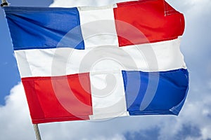 Dominican Republic National Flag Waving against sunny blue sky in Punta Cana