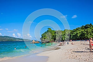 Dominican Republic. 20 NOVEMBER 2021. Caribbean beach with a lot of palms and white sand, sunbeds. Sunny warm day at the sea under