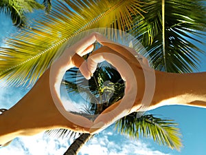 Dominican Republic, Punta cana, Mano Juan Beach. A couple in love doing a heart photo