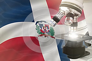 Dominican Republic science development concept - microscope on flag background. Research in genetics or biotechnology 3D