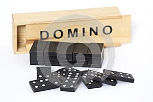 Domino game box and pieces on white background