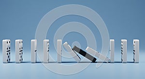 Domino Effect with One Different Piece Causing Falling photo
