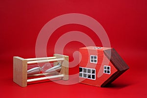 Domino effect of property home with Sand clock hourglass on red background , The impact of financial status and inflation or from