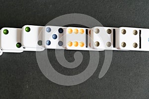 Domino effect shot. Look down for domino game on black background. Dominoes falling in a row in front. Dominoes Game