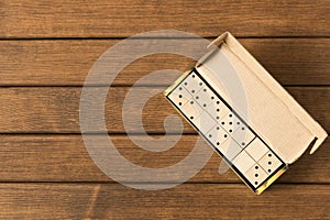 Domino. A game of dominoes on a wooden table