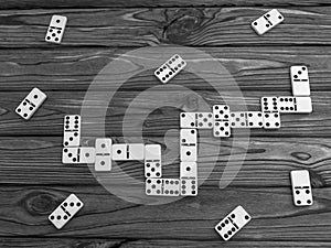 Domino pieces on the brown wooden table background