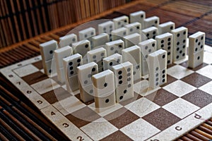 Domino pieces in a row on the bamboo brown wooden table background