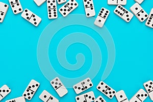 Domino pieces on turquoise blue background with copy space