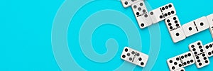 Domino pieces on turquoise blue background with copy space