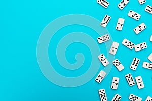 Domino pieces on turquoise blue background with copy space