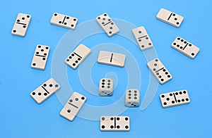 Domino and two dice background on blue abstract