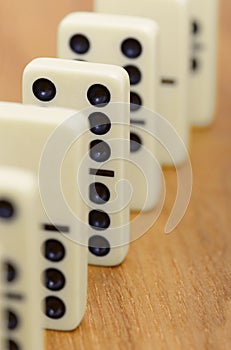 Dominoes on wooden surface abreast