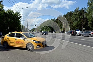 Yellow taxi car on Kashirskoye highway near Moscow