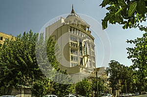 A beautiful building with a round dome with a spire, gazebos, columns and oval windows on Moalem Street in the capital Tehran