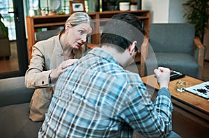 Don& x27;t be afraid of your feelings. Shot of a young man being comforted by his psychologist during a therapeutic