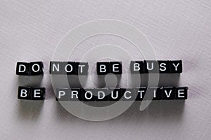 Don`t be busy, be productive on wooden blocks. Motivation and inspiration concept