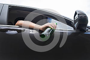 Don`t Drink for Drive concept, Young Drunk man drinking bottle of beer or alcohol during driving the car dangerously