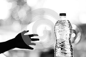 Don't get dehyrated, The shadow of a hand reaches towards a bottle of water