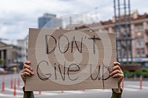 Don`t give up! Supportive cheering up sign at street outdoors.