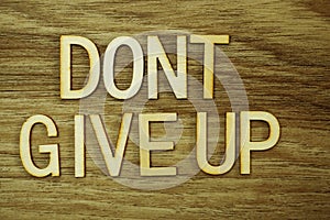 Don `t Give Up text message on wooden background