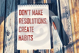 Don`t make decisions, don`t create habits, the phrase is written on a notebook.