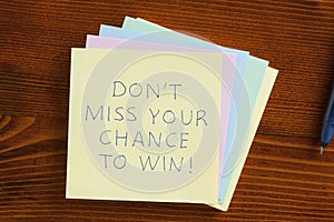Don't miss your chance to win written on a note photo