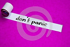 Don`t Panic text, Inspiration, Motivation and business concept on purple torn paper