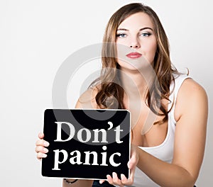 Don`t panic written on virtual screen. beautiful woman with bare shoulders holding pc tablet. technology, internet and