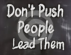 Don\'t Push People Lead Them - inspirational quote writen on a blackboard photo
