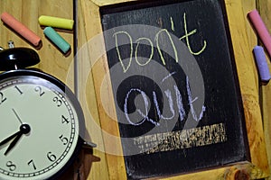 Don`t Quit on phrase colorful handwritten on chalkboard