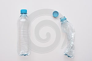 Don`t scrum your world. Two plastic bottles, one is crumble