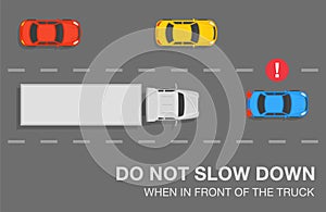 Don`t slow down when driving in front of the truck. Blue sedan car slows down in front of a truck on highway.