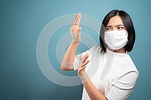 Don`t touch me. Asian woman wearing hygiene mask panic and disguted showing hand stop sign and standing