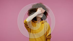 Don`t want to look at this! Girl afro hairstyle in hoodie avoiding watch something shameful, showing stop gesture, feeling shy sca