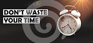 Don\'t waste time concept text with vintage alarm clock on black isolated background, banner