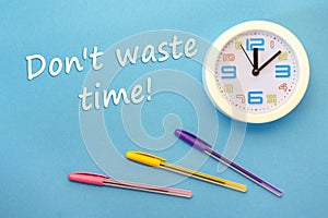 Don`t waste time - lettering on a blue background and clock